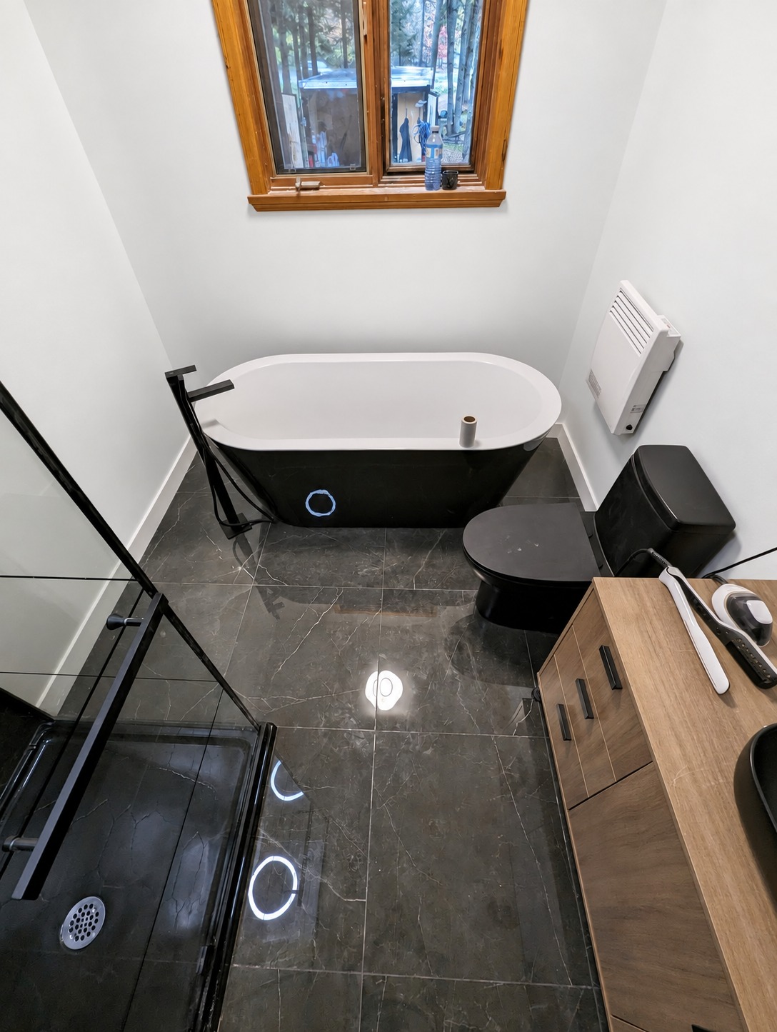 Completed black and white bathroom renovation by Herrera and Simard