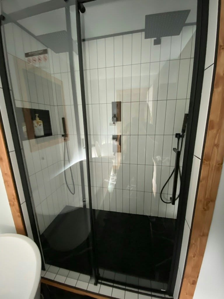 Custom shower with black frame glass